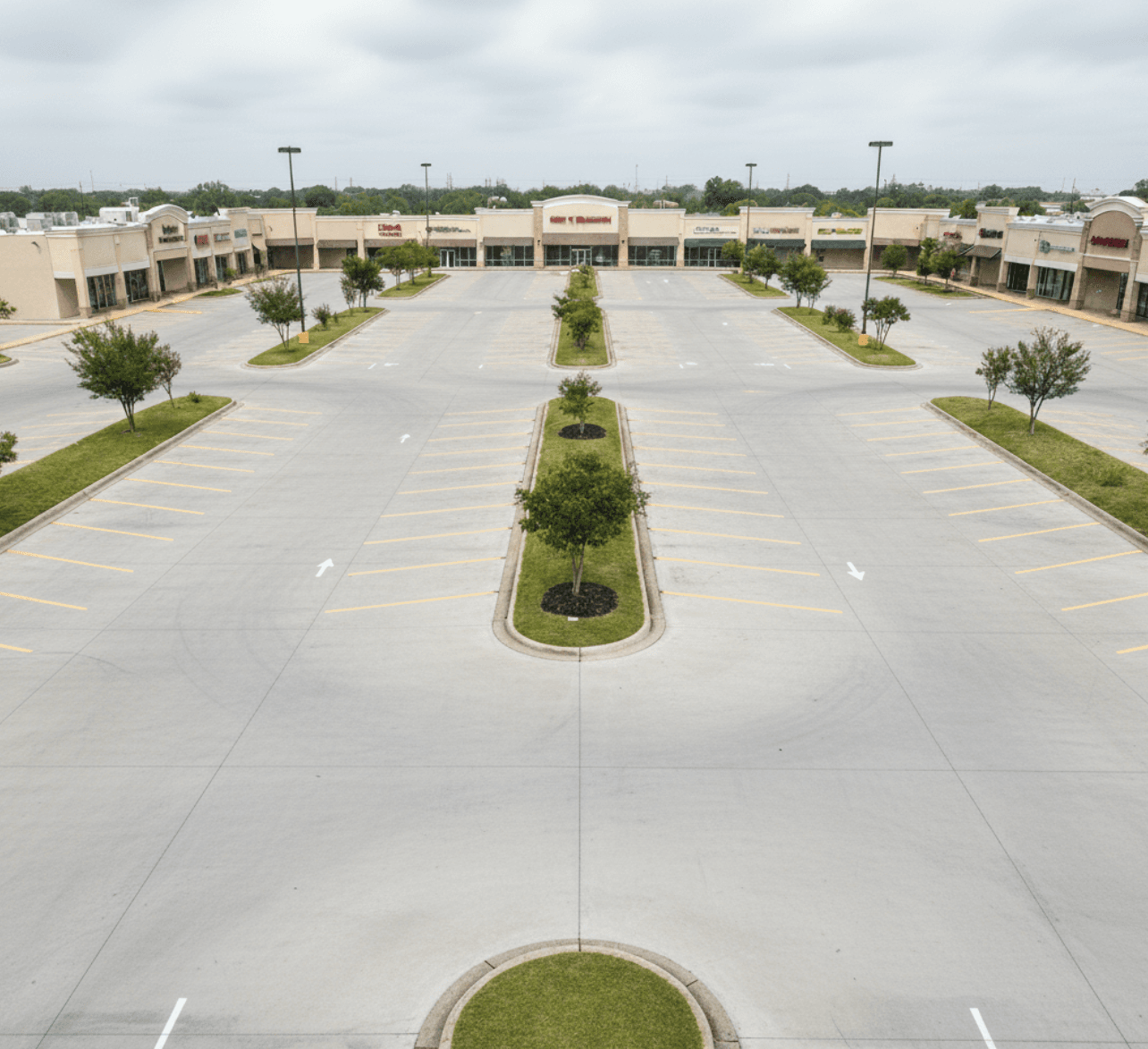Resurfaced shopping plaza lot with fresh striping in Baytown