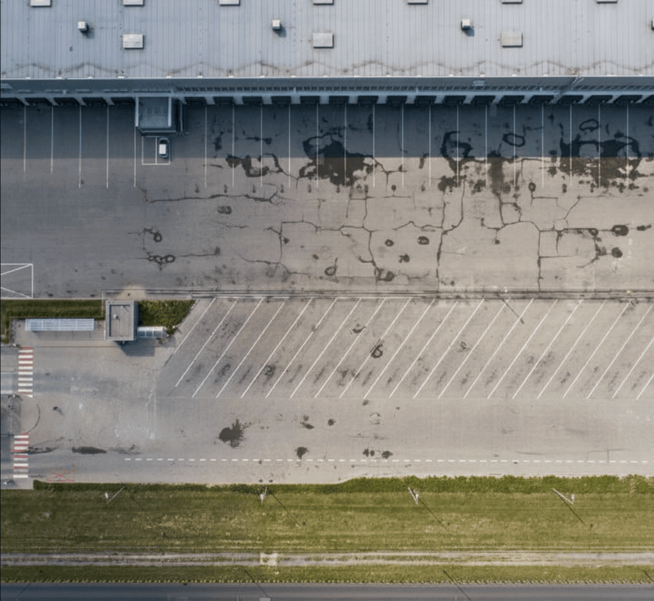 Distribution yard before with worn asphalt near Houston airport