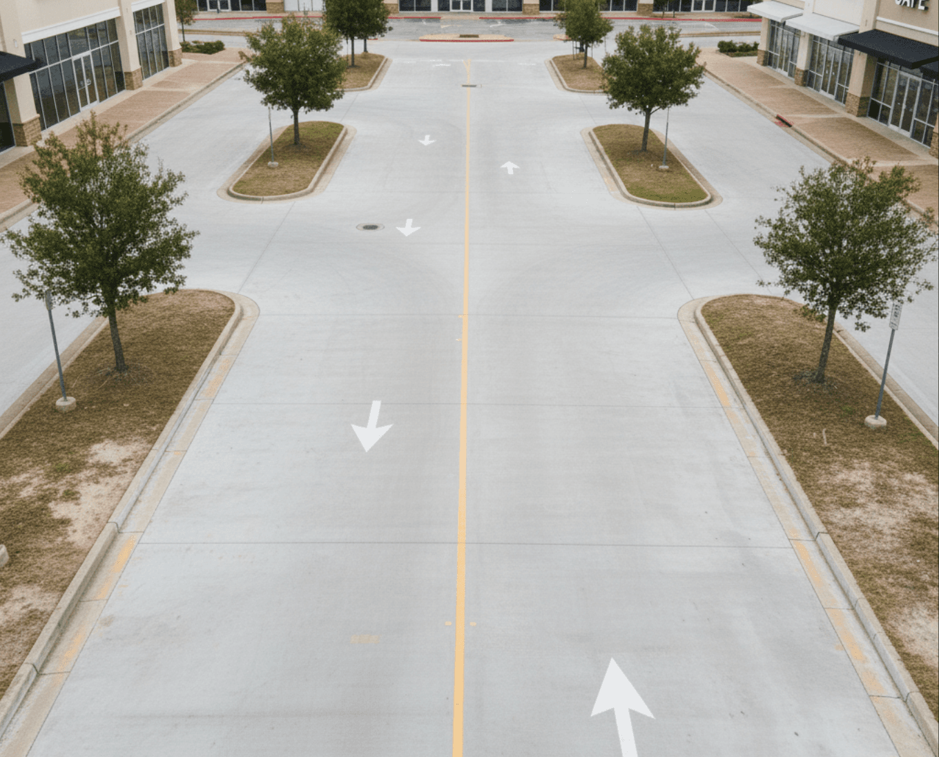 Completed drive lane with fresh asphalt and drainage inlet in Pearland